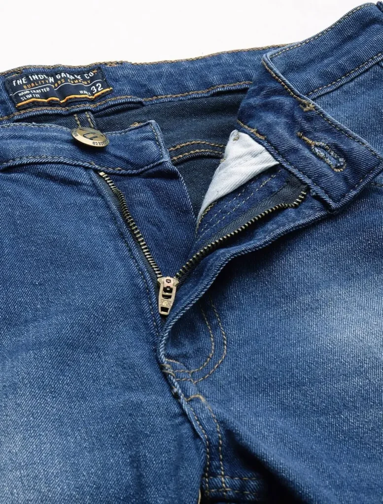 Man wearing mid-blue slim fit men's denim jeans with white sneakers